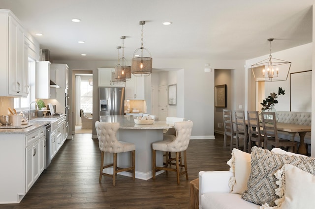 19530 102nd, Corcoran, MN 55374 - kitchen with stainless steel appliances, a kitchen island, recessed lighting, white cabinetry, and baseboards