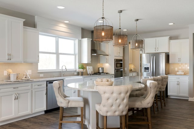 19530 102nd, Corcoran, MN 55374 - kitchen featuring appliances with stainless steel finishes, tasteful backsplash, wall chimney exhaust hood, recessed lighting, and white cabinets