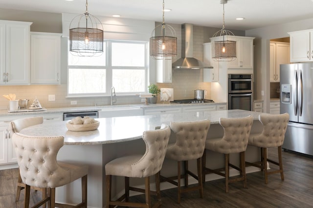 19530 102nd, Corcoran, MN 55374 - kitchen with appliances with stainless steel finishes, wall chimney range hood, a sink, decorative backsplash, and a kitchen island