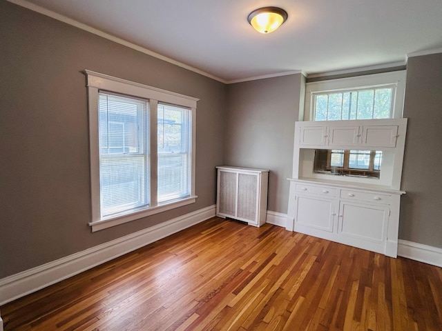 1536 Concordia Ave, Saint Paul, MN 55104 - empty room with ornamental molding, baseboards, wood finished floors, and healthy amount of natural light