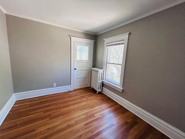 1536 Concordia Ave, Saint Paul, MN 55104 - unfurnished room with hardwood / wood-style flooring, baseboards, radiator heating unit, and ornamental molding