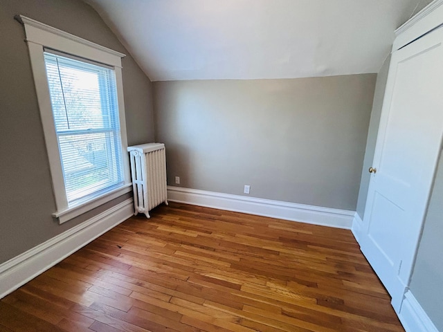 1536 Concordia Ave, Saint Paul, MN 55104 - additional living space with radiator heating unit, vaulted ceiling, hardwood / wood-style flooring, and baseboards
