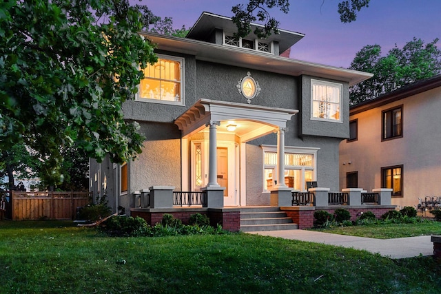 view of front facade featuring covered porch and stucco siding