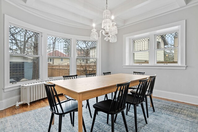 dining room with ornamental molding, baseboards, a chandelier, coffered ceiling, and wood finished floors