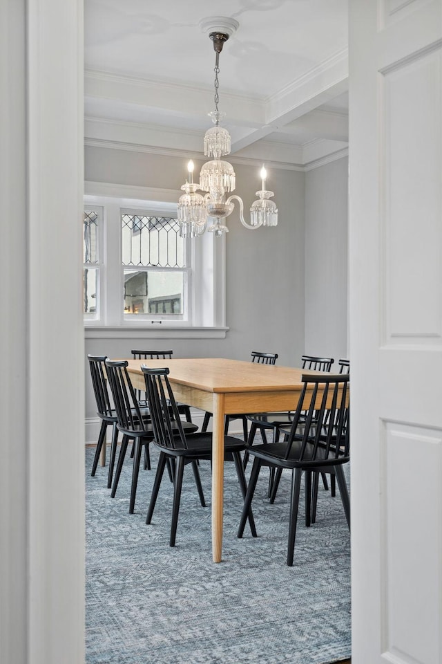 dining space with a chandelier, crown molding, beamed ceiling, carpet floors, and baseboards