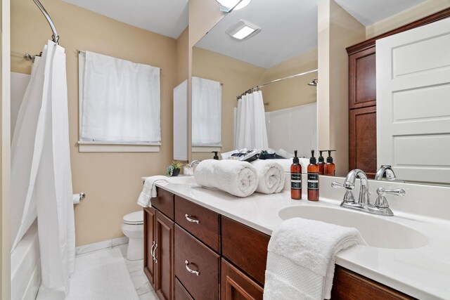 full bathroom with toilet, vanity, and baseboards