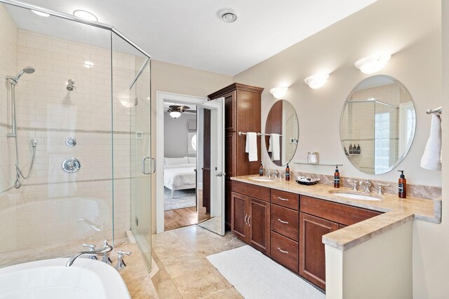 full bath featuring a stall shower, double vanity, a bathtub, ensuite bath, and tile patterned floors
