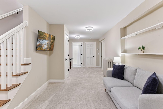 corridor featuring radiator heating unit, carpet flooring, baseboards, and stairs