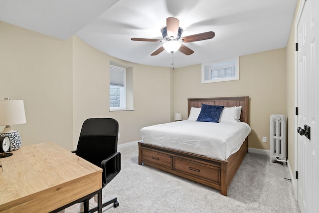 bedroom featuring radiator, light colored carpet, and multiple windows