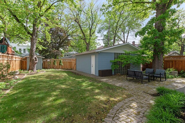 view of yard with a patio and an outdoor structure