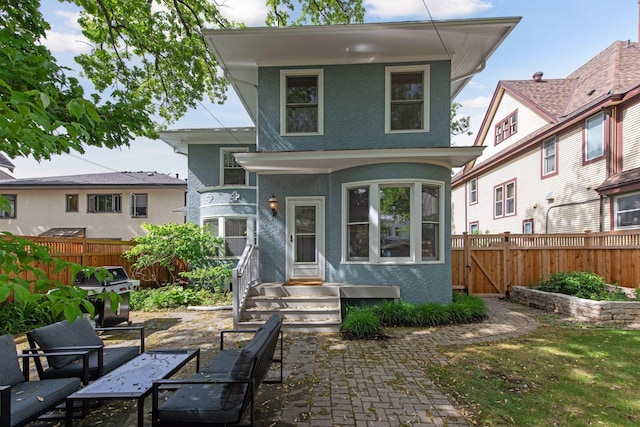 back of property featuring stucco siding and a fenced backyard