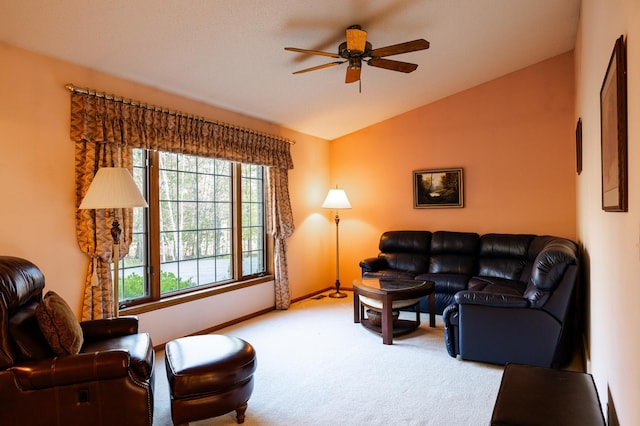 carpeted living room with lofted ceiling, a ceiling fan, and baseboards