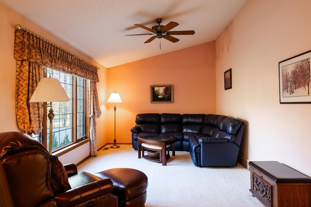 carpeted living area with vaulted ceiling, ceiling fan, and baseboards