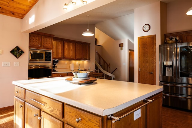 kitchen featuring appliances with stainless steel finishes, lofted ceiling, dark wood-type flooring, light countertops, and wooden ceiling