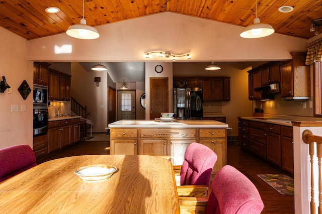 kitchen featuring black refrigerator with ice dispenser, vaulted ceiling, under cabinet range hood, light countertops, and wood ceiling