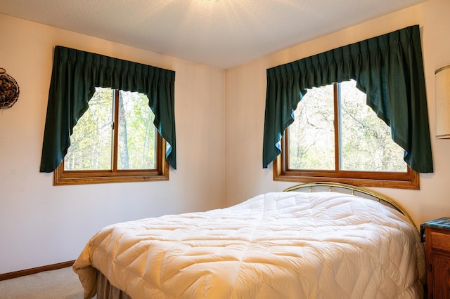 bedroom featuring carpet flooring and baseboards