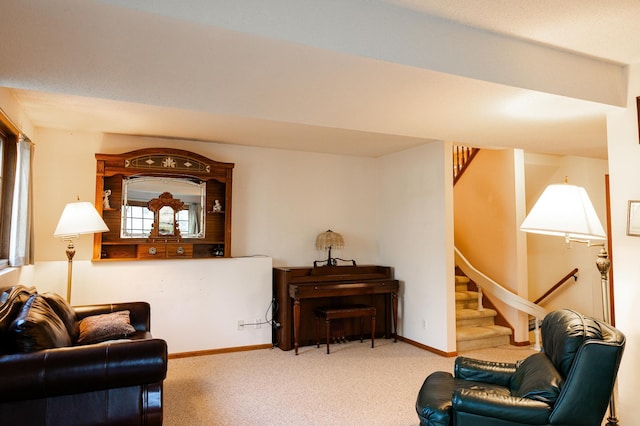 living area featuring stairs, carpet flooring, and baseboards
