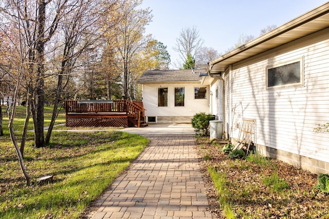 view of yard with a wooden deck and a patio area