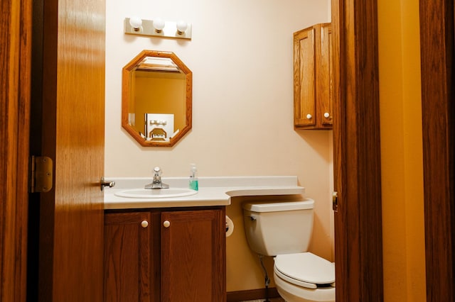 half bath featuring toilet and vanity