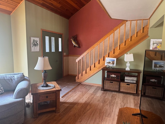 7525 Filbert Ln NE, Turtle River Twp, MN 56601 - living area with stairs, wooden ceiling, wood finished floors, wainscoting, and lofted ceiling