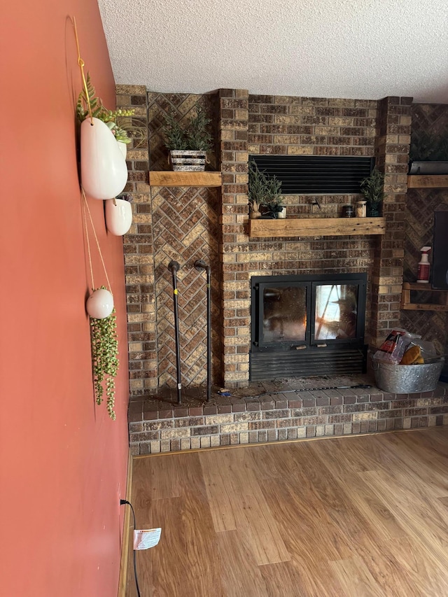 7525 Filbert Ln NE, Turtle River Twp, MN 56601 - unfurnished living room featuring a fireplace, a textured ceiling, and wood finished floors