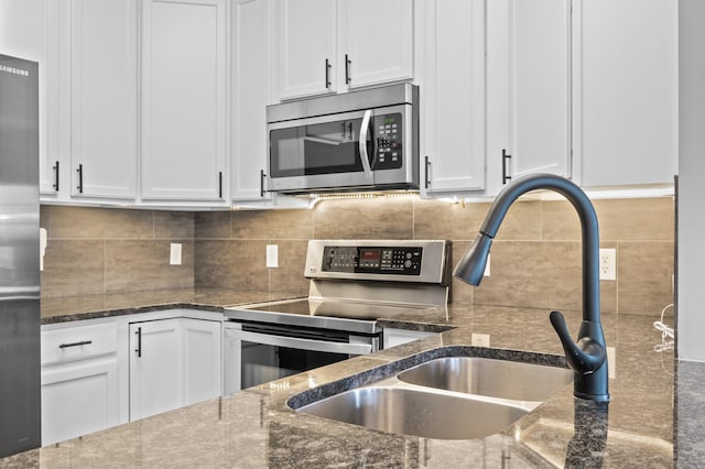 kitchen featuring appliances with stainless steel finishes and white cabinetry