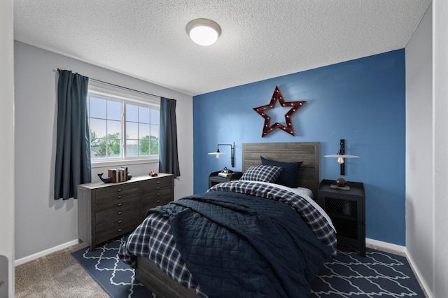 carpeted bedroom with a textured ceiling and baseboards