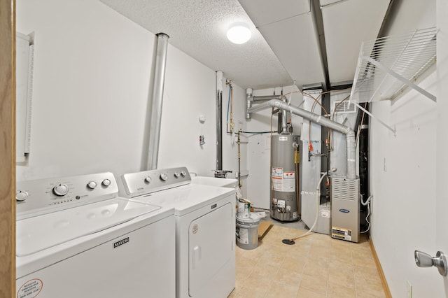 laundry area with washer and clothes dryer, gas water heater, light tile patterned flooring, heating unit, and baseboards