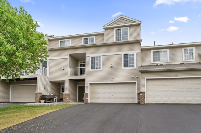 multi unit property with driveway and a garage