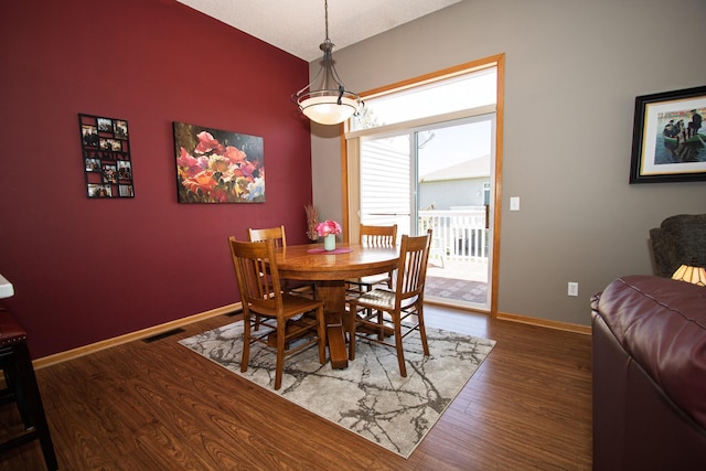 dining room with wood finished floors and baseboards