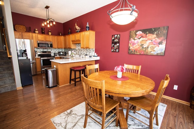 dining space featuring dark wood-style floors