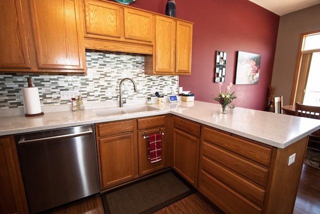 kitchen with dishwasher, a sink, a peninsula, and light countertops