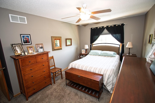 bedroom with carpet flooring, ceiling fan, and a textured ceiling
