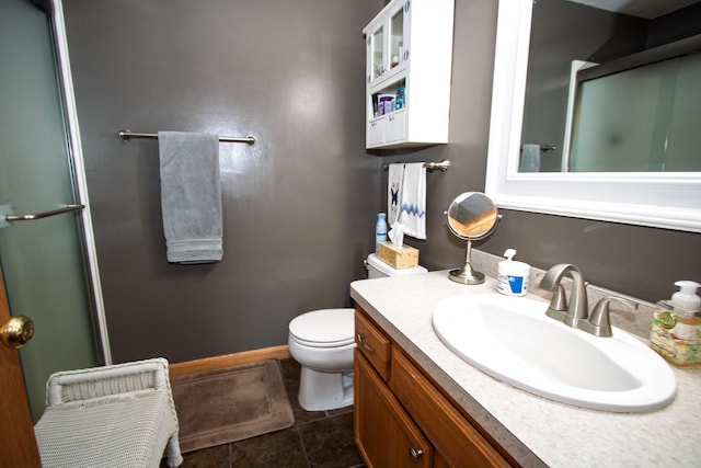 bathroom with a shower with door, toilet, tile patterned flooring, vanity, and baseboards