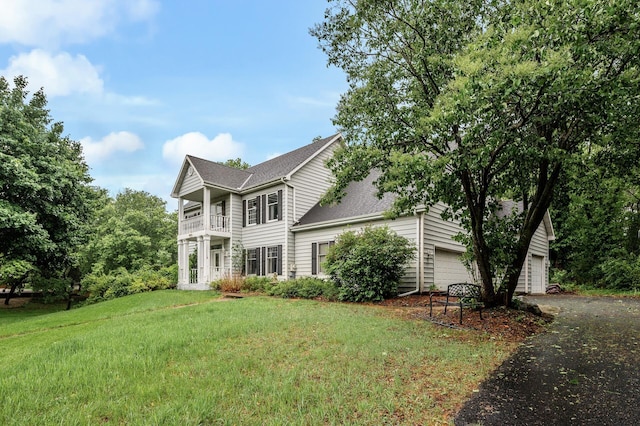 2401 Omeara Ct, Burnsville, MN 55306 - view of front facade featuring driveway, a front lawn, a balcony, and a shingled roof