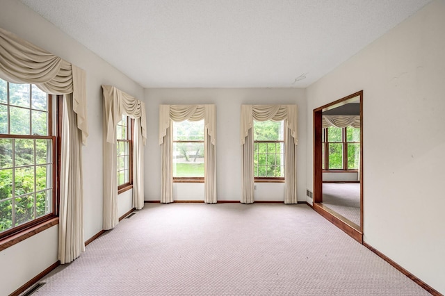 2401 Omeara Ct, Burnsville, MN 55306 - empty room with healthy amount of natural light, light colored carpet, and baseboards
