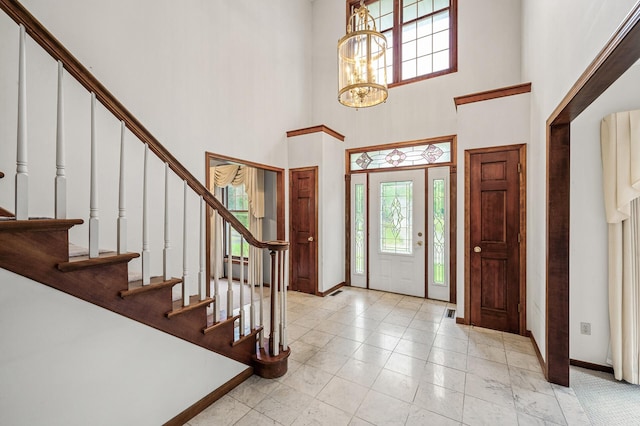 2401 Omeara Ct, Burnsville, MN 55306 - entryway with baseboards, stairs, a towering ceiling, and a chandelier