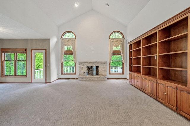 2401 Omeara Ct, Burnsville, MN 55306 - unfurnished living room featuring high vaulted ceiling, light colored carpet, a fireplace, and baseboards