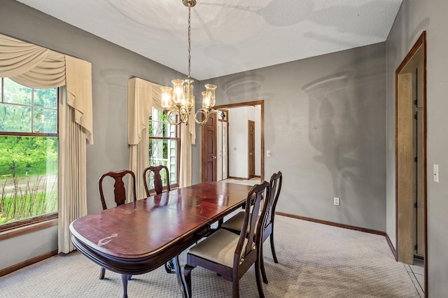 2401 Omeara Ct, Burnsville, MN 55306 - dining space with a chandelier, light colored carpet, and baseboards