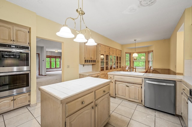 2401 Omeara Ct, Burnsville, MN 55306 - kitchen with appliances with stainless steel finishes, tile counters, a sink, and light brown cabinetry