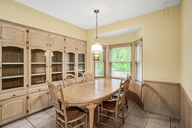 2401 Omeara Ct, Burnsville, MN 55306 - dining space with light tile patterned floors and a wainscoted wall