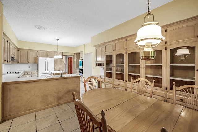 2401 Omeara Ct, Burnsville, MN 55306 - dining room with light tile patterned floors and a textured ceiling