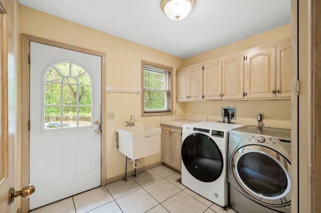 2401 Omeara Ct, Burnsville, MN 55306 - laundry area featuring cabinet space, washing machine and clothes dryer, healthy amount of natural light, and light tile patterned floors