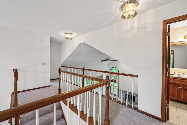 2401 Omeara Ct, Burnsville, MN 55306 - hall with light colored carpet, baseboards, a textured ceiling, a sink, and plenty of natural light