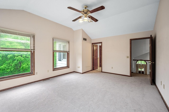 2401 Omeara Ct, Burnsville, MN 55306 - spare room with lofted ceiling, light colored carpet, ceiling fan, and baseboards