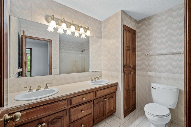 2401 Omeara Ct, Burnsville, MN 55306 - full bath featuring double vanity, a textured ceiling, tiled shower, tile patterned floors, and toilet