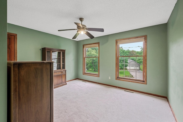 2401 Omeara Ct, Burnsville, MN 55306 - carpeted empty room featuring baseboards, a ceiling fan, and a textured ceiling