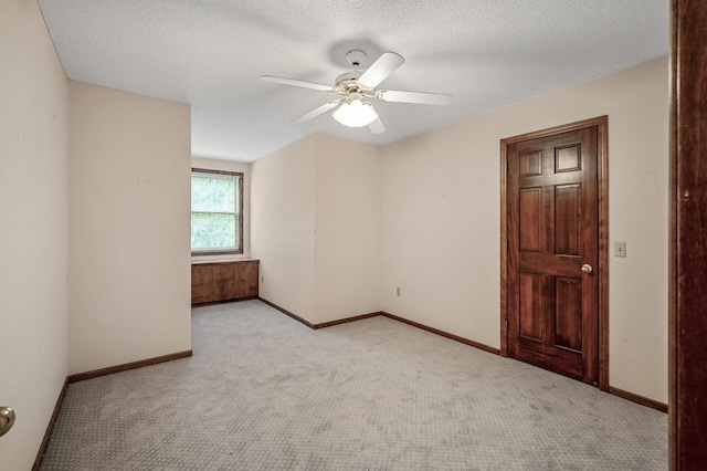 2401 Omeara Ct, Burnsville, MN 55306 - spare room featuring carpet flooring, ceiling fan, a textured ceiling, and baseboards