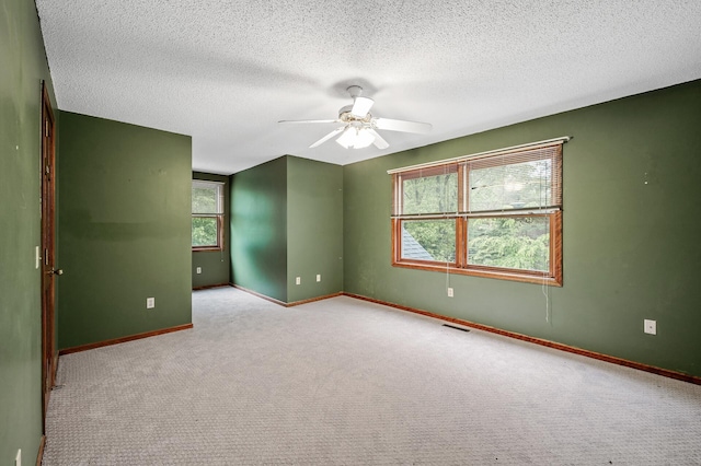2401 Omeara Ct, Burnsville, MN 55306 - empty room with plenty of natural light, ceiling fan, baseboards, and a textured ceiling
