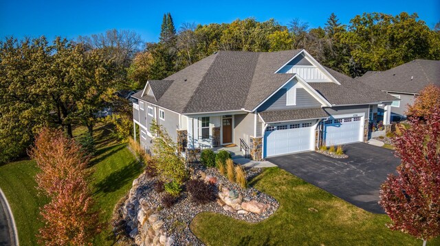 17796 Junelle Ct, Lakeville, MN 55044 - view of front of house featuring covered porch, a garage, asphalt driveway, and a front lawn